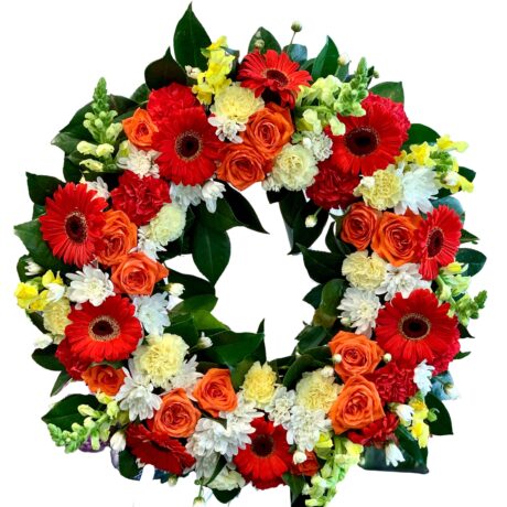 Orange Roses and Red Gerberas Round Funeral Wreath